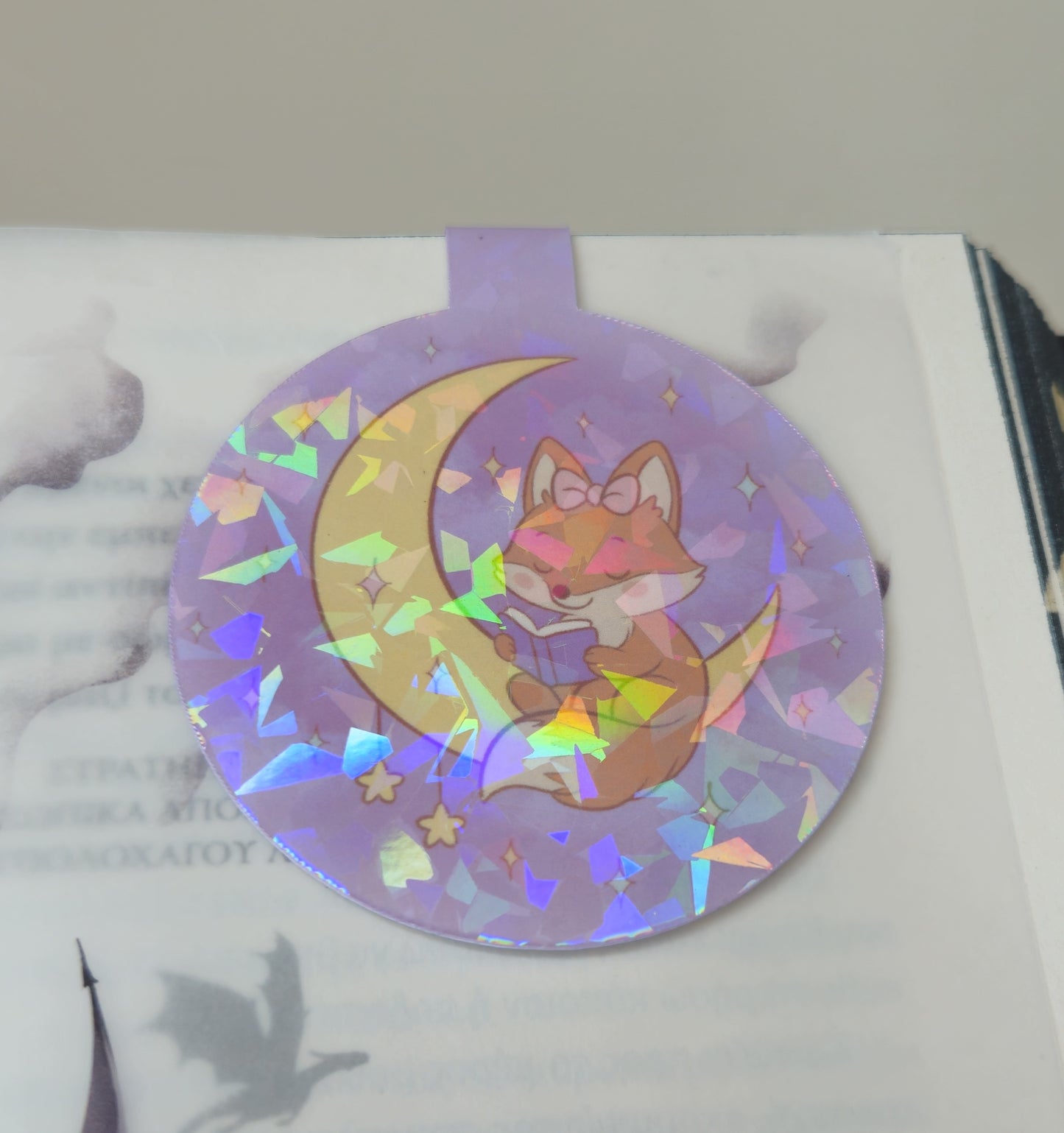 Holographic sticker with a fox and moon design on a white surface