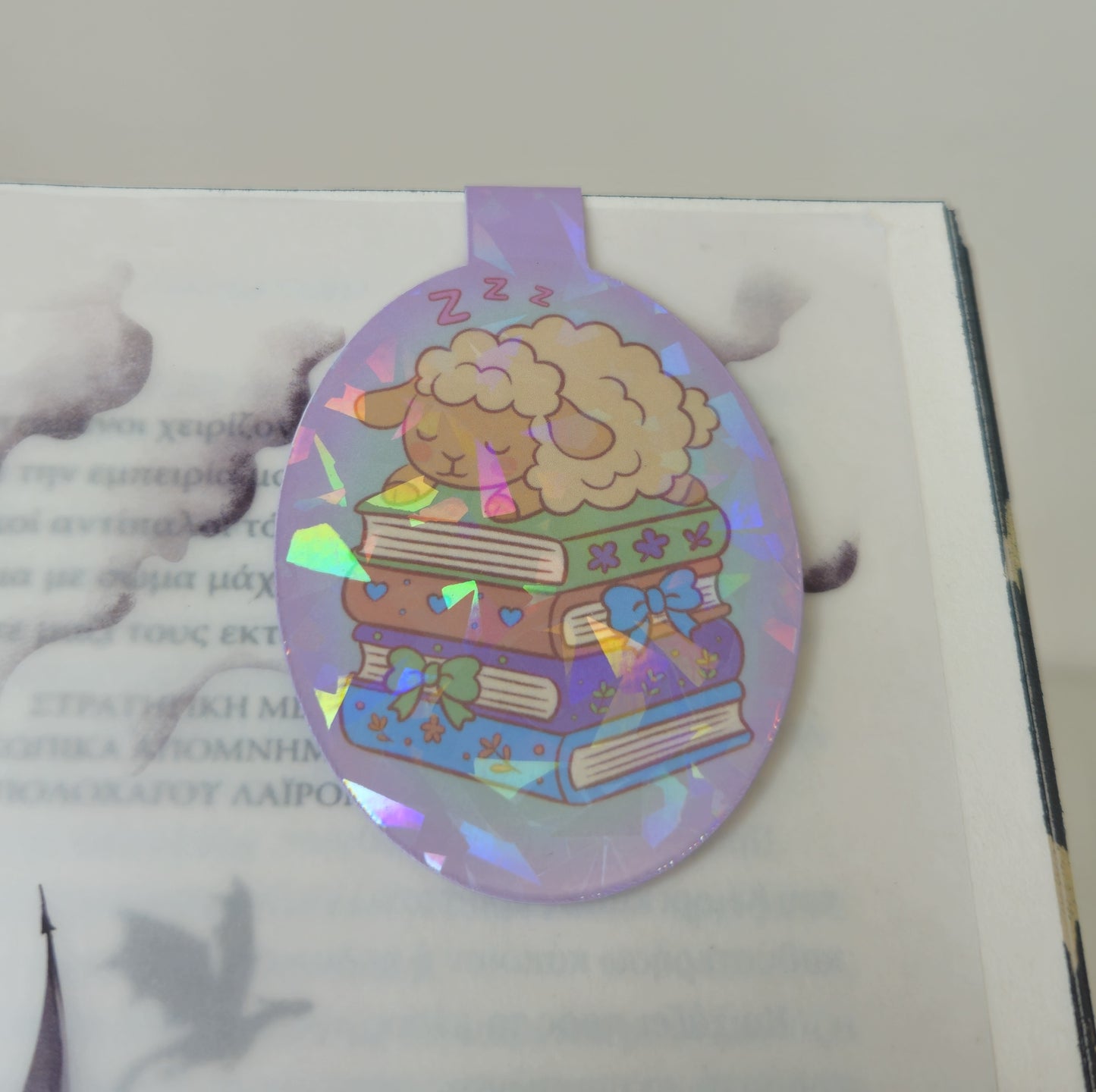 Holographic bookmark with a sheep design on a book