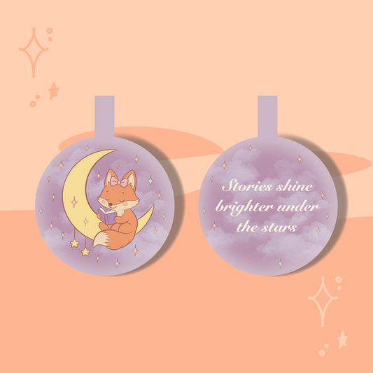 Decorative tag with a fox reading on a crescent moon, surrounded by stars, on a pink background.